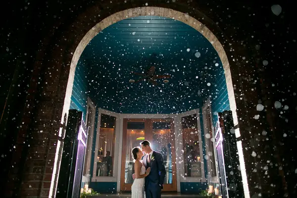Bride and groom at evening Washington wedding venue with brick archway and candlelit florals. Lovely Events.