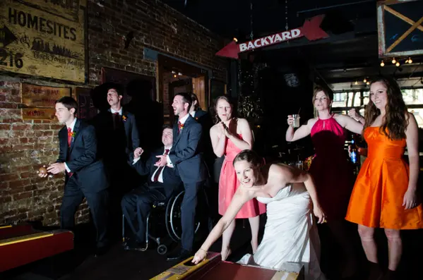 Wedding party at indoor Seattle-area reception with games and rustic venue. Lovely Events.