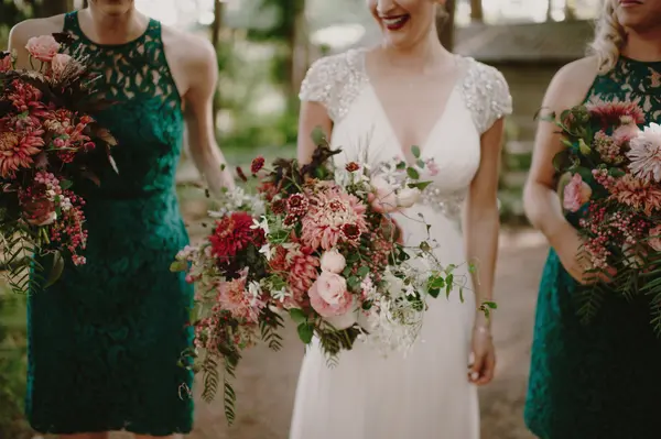 Bride and bridesmaids with floral bouquets at outdoor Seattle-area wedding. Lovely Events.