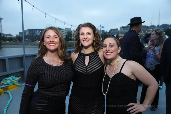 Wedding guests on waterfront deck at Seattle-area evening event. Lovely Events.