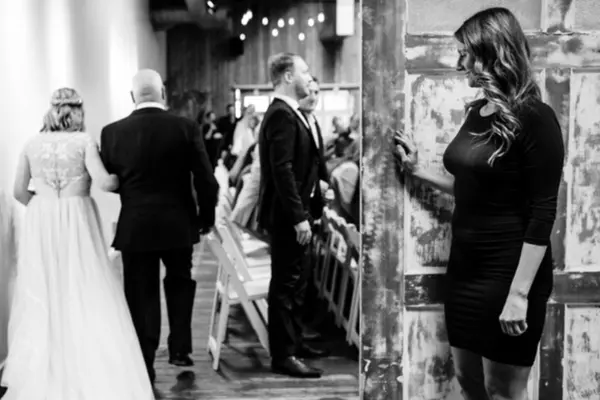 Wedding procession down aisle at indoor rustic Seattle-area venue. Lovely Events.