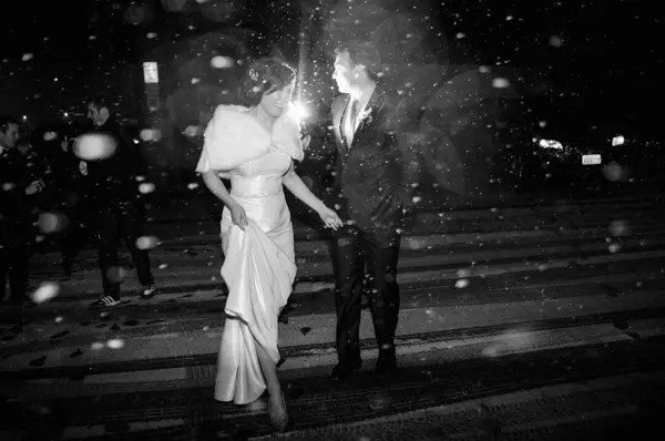 Bride and groom in winter wedding exit at night in Pacific Northwest. Lovely Events.